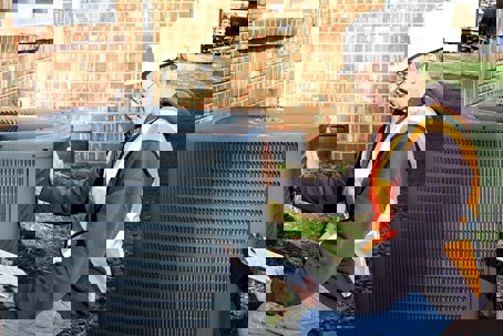 technician checking on compressor