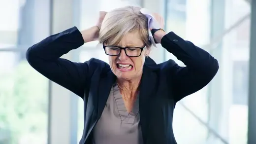 A frustrated person tears at their hair