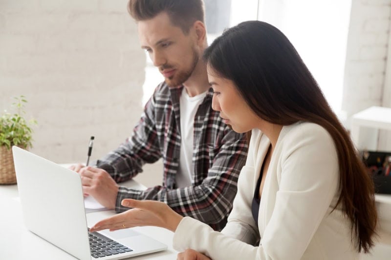 Summer Savings Tips for AC. Couple at computer.