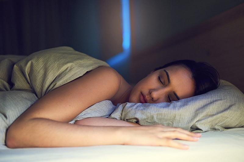 Shot of a young woman sound asleep in her bedroom|Hand in yellow glove and vacuum cleaner pipe. Ventilation grill cleaning. Air Handler Maintenance.