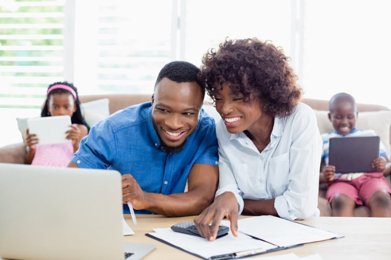 Air Conditioners: Things You May Not Have Known. Couple sitting at table and calculating bills at home.