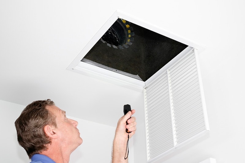 man inspecting ceiling vent, Listen to Your HVAC System | Shearer Heating, A/C | McMurray, PA